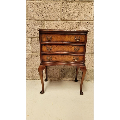 74 - A SERPENTINE SHAPED THREE DRAWER CHEST / CABINET / LOCKER, the edge decorated with carved gadrooned ... 