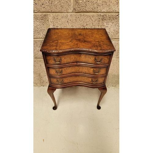 74 - A SERPENTINE SHAPED THREE DRAWER CHEST / CABINET / LOCKER, the edge decorated with carved gadrooned ... 