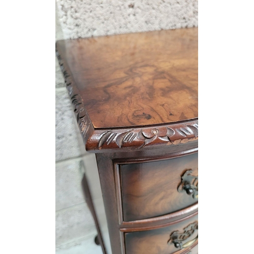 74 - A SERPENTINE SHAPED THREE DRAWER CHEST / CABINET / LOCKER, the edge decorated with carved gadrooned ... 