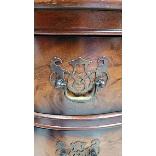74 - A SERPENTINE SHAPED THREE DRAWER CHEST / CABINET / LOCKER, the edge decorated with carved gadrooned ... 
