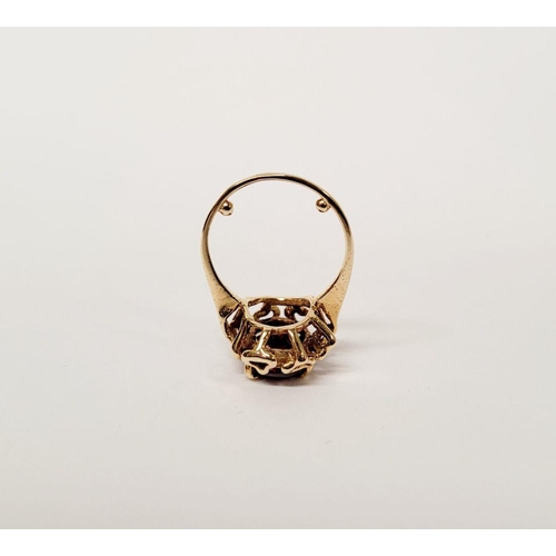 78 - A BEAUTIFUL YELLOW GOLD & GARNET RING, with an open work edge that holds the large oval shaped garne... 