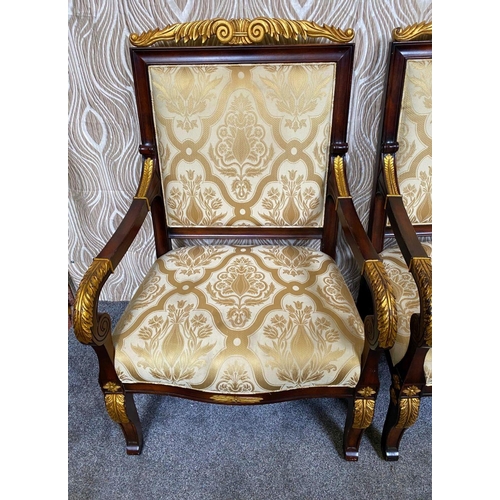 88 - A PAIR OF CARVED GILT DECORATED UPHOLSTERED ARMCHAIRS, each with scrolling foliage detail to the cre... 