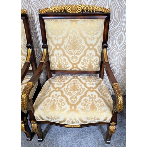 88 - A PAIR OF CARVED GILT DECORATED UPHOLSTERED ARMCHAIRS, each with scrolling foliage detail to the cre... 