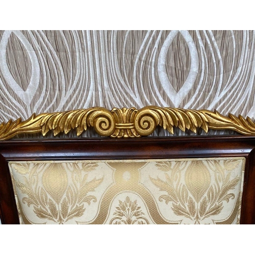 88 - A PAIR OF CARVED GILT DECORATED UPHOLSTERED ARMCHAIRS, each with scrolling foliage detail to the cre... 