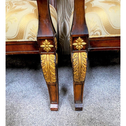 88 - A PAIR OF CARVED GILT DECORATED UPHOLSTERED ARMCHAIRS, each with scrolling foliage detail to the cre... 