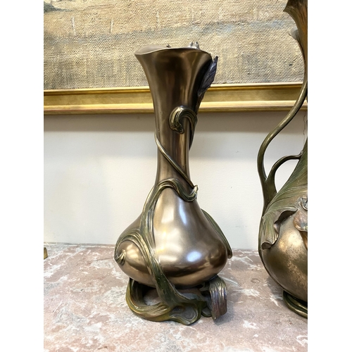 100 - TWO DECORATIVE VERONESE BRONZE PLATED VASES, the larger ewer vase with lotus leaf design to handle a... 