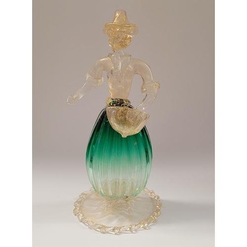 105 - A VINTAGE MURANO STYLE GLASS ORNAMENTAL FIGURINE, depicting a figure holding a basket. The skirt in ... 