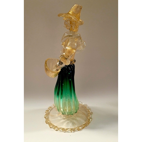 105 - A VINTAGE MURANO STYLE GLASS ORNAMENTAL FIGURINE, depicting a figure holding a basket. The skirt in ... 