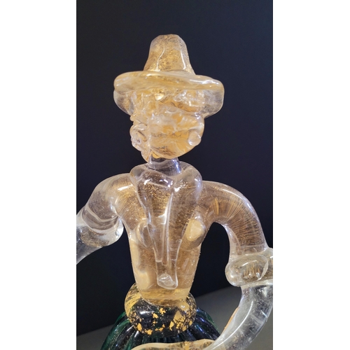 105 - A VINTAGE MURANO STYLE GLASS ORNAMENTAL FIGURINE, depicting a figure holding a basket. The skirt in ... 