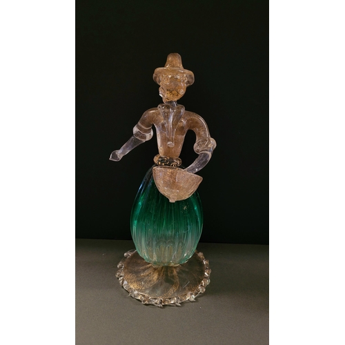 105 - A VINTAGE MURANO STYLE GLASS ORNAMENTAL FIGURINE, depicting a figure holding a basket. The skirt in ... 