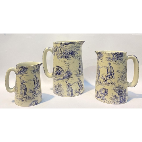 109 - A SET OF THREE BRITISH POTTERY ‘TOILE DE JOUY’ JUGS, in the style of Heron Cross Pottery, each piece... 