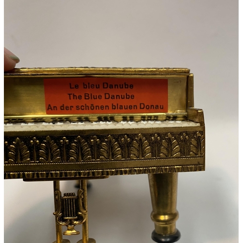 11 - A CHARMING AUSTRIAN GILT ORMOLU PIANO MUSIC BOX, by Reuge, this miniature piano is decorated with a ... 