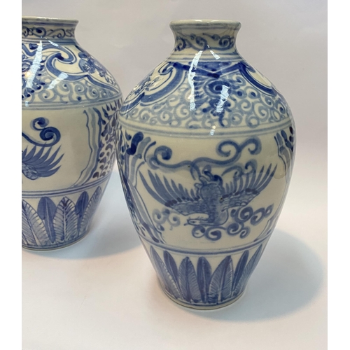 118 - A PAIR OF PAINTED PORCELAIN BLUE AND WHITE VASES, inverted bulbous form with narrow neck, decorated ... 