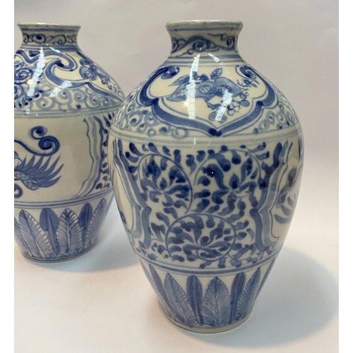 118 - A PAIR OF PAINTED PORCELAIN BLUE AND WHITE VASES, inverted bulbous form with narrow neck, decorated ... 