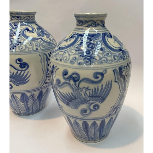 118 - A PAIR OF PAINTED PORCELAIN BLUE AND WHITE VASES, inverted bulbous form with narrow neck, decorated ... 