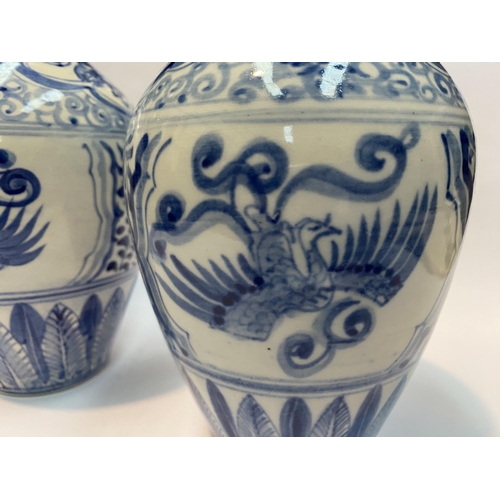 118 - A PAIR OF PAINTED PORCELAIN BLUE AND WHITE VASES, inverted bulbous form with narrow neck, decorated ... 