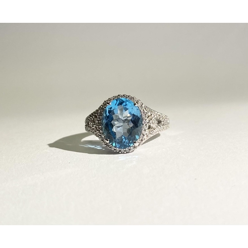 13 - AN EXQUISITE 18CT WHITE GOLD BLUE TOPAZ AND DIAMOND CLUSTER RING, with central large sparkling oval ... 