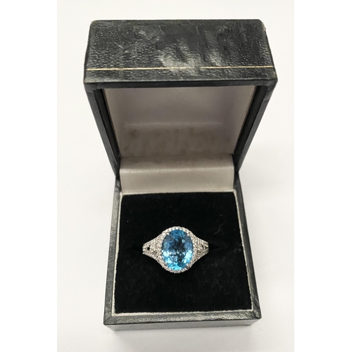 13 - AN EXQUISITE 18CT WHITE GOLD BLUE TOPAZ AND DIAMOND CLUSTER RING, with central large sparkling oval ... 