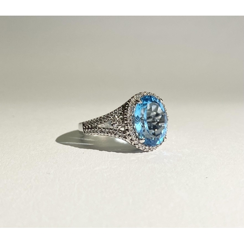 13 - AN EXQUISITE 18CT WHITE GOLD BLUE TOPAZ AND DIAMOND CLUSTER RING, with central large sparkling oval ... 