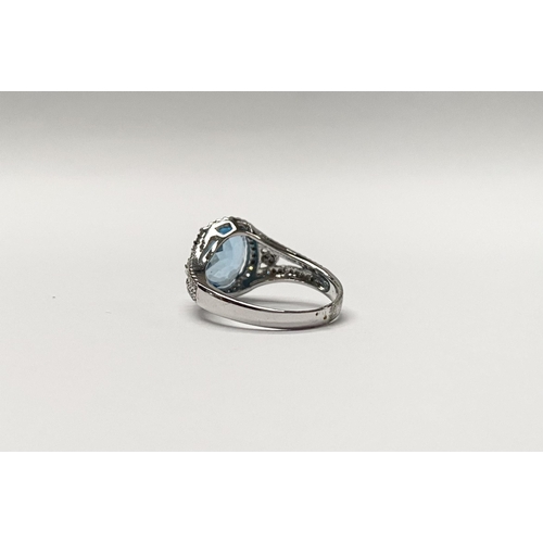 13 - AN EXQUISITE 18CT WHITE GOLD BLUE TOPAZ AND DIAMOND CLUSTER RING, with central large sparkling oval ... 