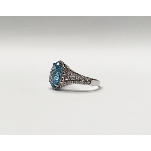 13 - AN EXQUISITE 18CT WHITE GOLD BLUE TOPAZ AND DIAMOND CLUSTER RING, with central large sparkling oval ... 