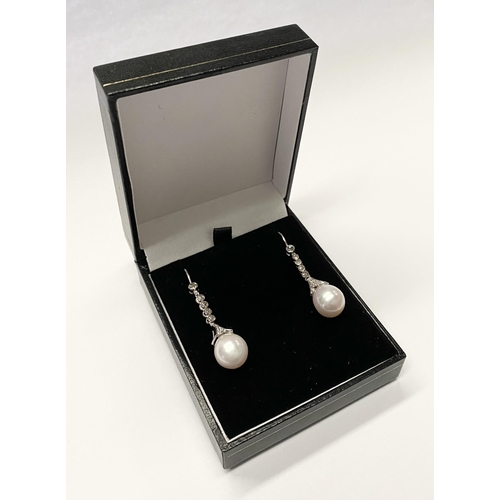 137 - A BEAUTIFUL PAIR OF 18CT WHITE GOLD SOUTH SEA PEARL AND DIAMOND DROP EARRINGS, with five round cut d... 