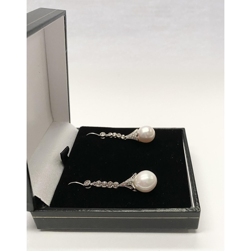 137 - A BEAUTIFUL PAIR OF 18CT WHITE GOLD SOUTH SEA PEARL AND DIAMOND DROP EARRINGS, with five round cut d... 