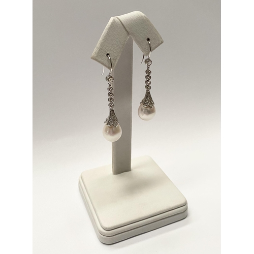 137 - A BEAUTIFUL PAIR OF 18CT WHITE GOLD SOUTH SEA PEARL AND DIAMOND DROP EARRINGS, with five round cut d... 