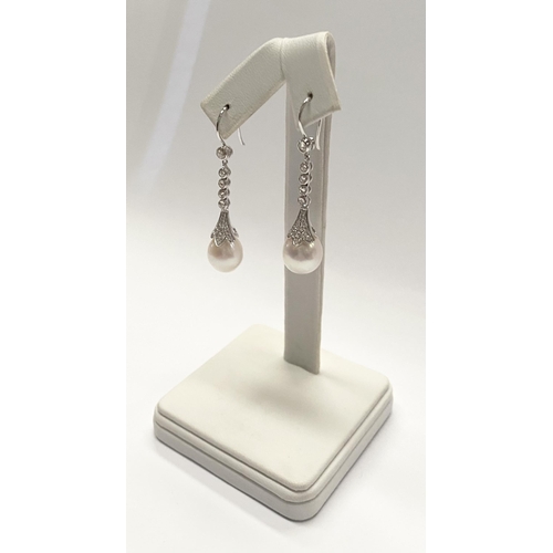 137 - A BEAUTIFUL PAIR OF 18CT WHITE GOLD SOUTH SEA PEARL AND DIAMOND DROP EARRINGS, with five round cut d... 