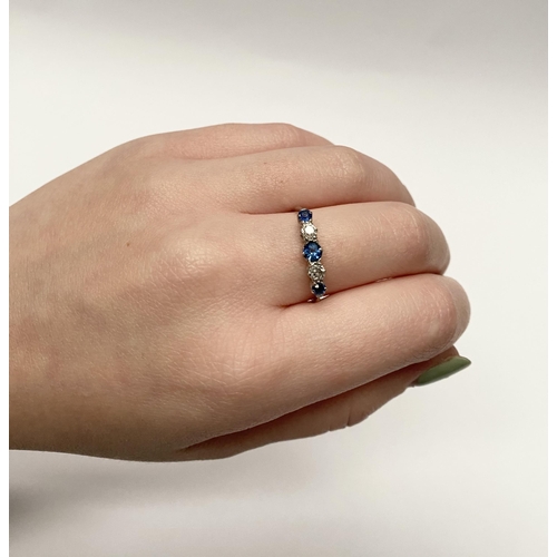 140 - A DAINTY 18CT WHITE GOLD FIVE STONE SAPPHIRE AND DIAMOND RING, with three vibrant round cut sapphire... 