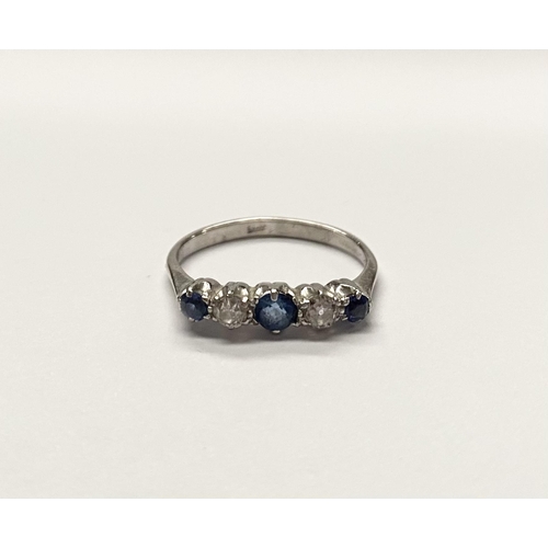 140 - A DAINTY 18CT WHITE GOLD FIVE STONE SAPPHIRE AND DIAMOND RING, with three vibrant round cut sapphire... 