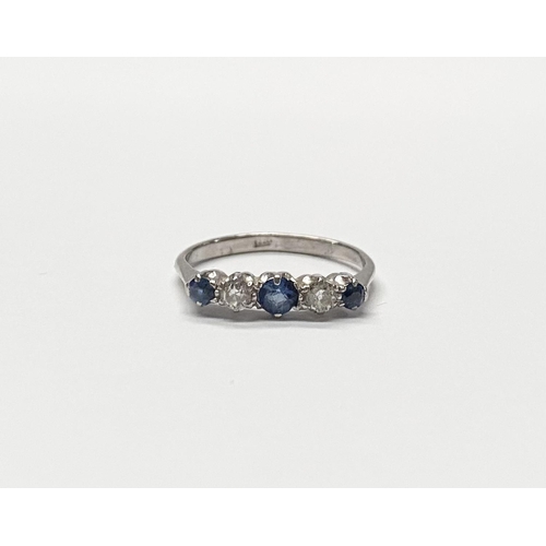 140 - A DAINTY 18CT WHITE GOLD FIVE STONE SAPPHIRE AND DIAMOND RING, with three vibrant round cut sapphire... 