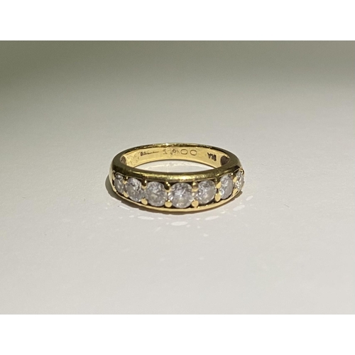 141 - A SPARKLING 18CT YELLOW GOLD SEVEN STONE DIAMOND BAND, with seven round cut diamonds in 18ct yellow ... 