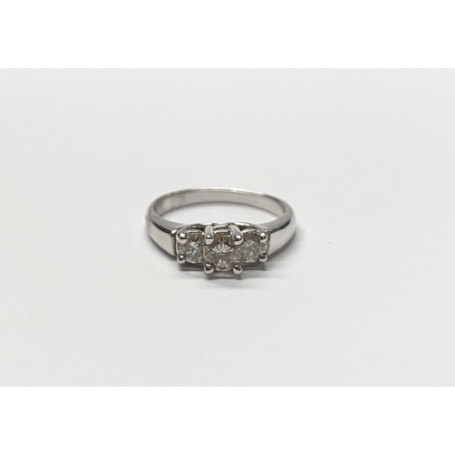 143 - A TRADITIONAL 18CT WHITE GOLD THREE STONE DIAMOND RING, with three round cut diamonds in raised pron... 