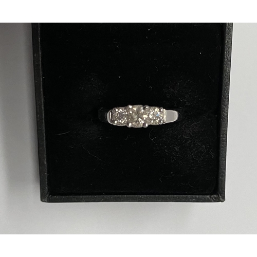 143 - A TRADITIONAL 18CT WHITE GOLD THREE STONE DIAMOND RING, with three round cut diamonds in raised pron... 