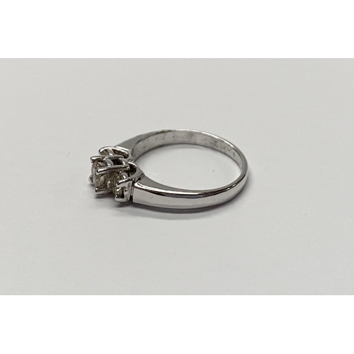 143 - A TRADITIONAL 18CT WHITE GOLD THREE STONE DIAMOND RING, with three round cut diamonds in raised pron... 