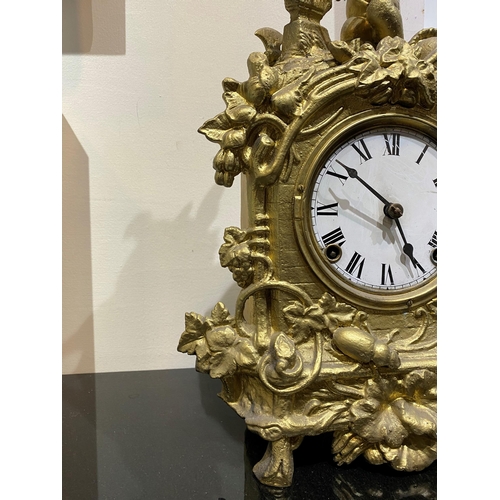 147 - A DECORATIVE VINTAGE FRENCH STYLE GILT MANTLE CLOCK, with roman numerals to dial within highly decor... 