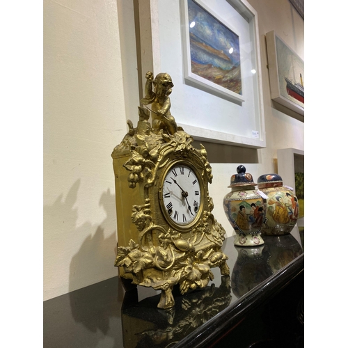 147 - A DECORATIVE VINTAGE FRENCH STYLE GILT MANTLE CLOCK, with roman numerals to dial within highly decor... 