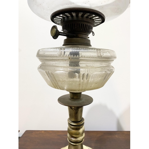 151 - A BEAUTIFUL VICTORIAN OIL LAMP, the opaque white glass shade with ruffled rim, with double burner an... 