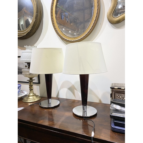 152 - A PAIR OF CHROME AND ROSEWOOD STYLE TABLE LAMPS, with tapered support atop circular base. Dimensions... 