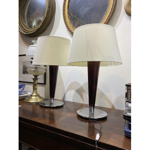 152 - A PAIR OF CHROME AND ROSEWOOD STYLE TABLE LAMPS, with tapered support atop circular base. Dimensions... 