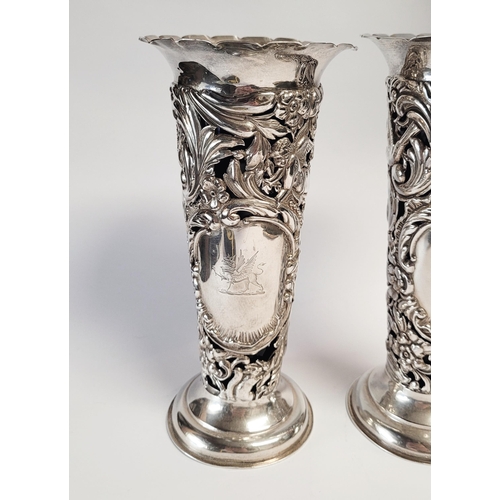 157 - A LATE 19TH CENTURY PAIR OF SILVER BUD VASES, with purple glass liners, each vase decorated all over... 