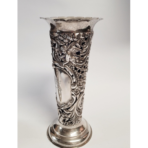 157 - A LATE 19TH CENTURY PAIR OF SILVER BUD VASES, with purple glass liners, each vase decorated all over... 