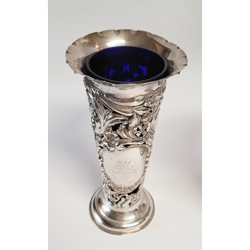 157 - A LATE 19TH CENTURY PAIR OF SILVER BUD VASES, with purple glass liners, each vase decorated all over... 