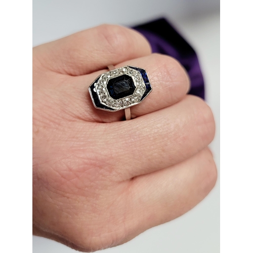 158 - A FRENCH ART DECO SAPPHIRE & DIAMOND CLUSTER RING, with a central dark sapphire surrounded by a fram... 