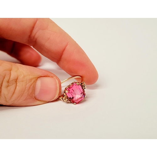 17 - A 10CT YELLOW GOLD BRIGHT PINK TOPAZ RING. The stone is very pretty – with a lovely shade of pink, t... 