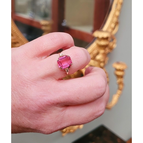 17 - A 10CT YELLOW GOLD BRIGHT PINK TOPAZ RING. The stone is very pretty – with a lovely shade of pink, t... 