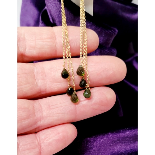 183 - A PRETTY PAIR OF HANGING PERIDOT DROP EARRINGS, each earring with a beautiful trail of peridot stone... 