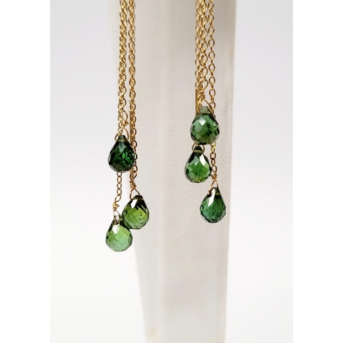 183 - A PRETTY PAIR OF HANGING PERIDOT DROP EARRINGS, each earring with a beautiful trail of peridot stone... 