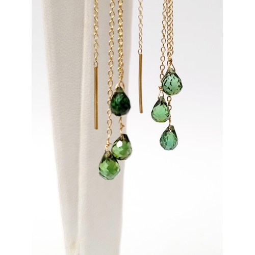 183 - A PRETTY PAIR OF HANGING PERIDOT DROP EARRINGS, each earring with a beautiful trail of peridot stone... 